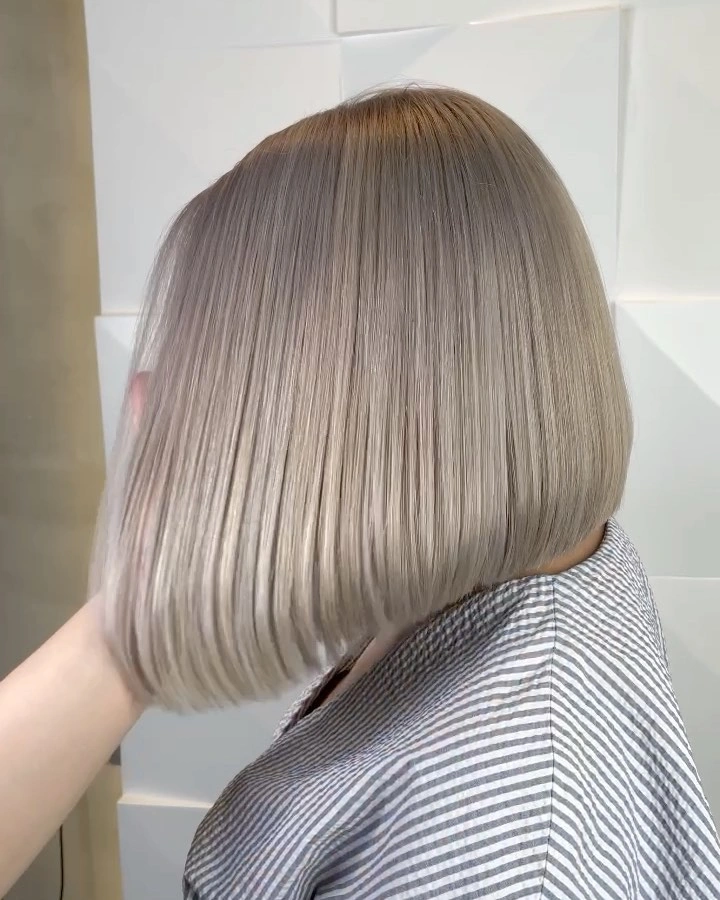 Smooth ash silver bob with subtle gray tones and blunt ends