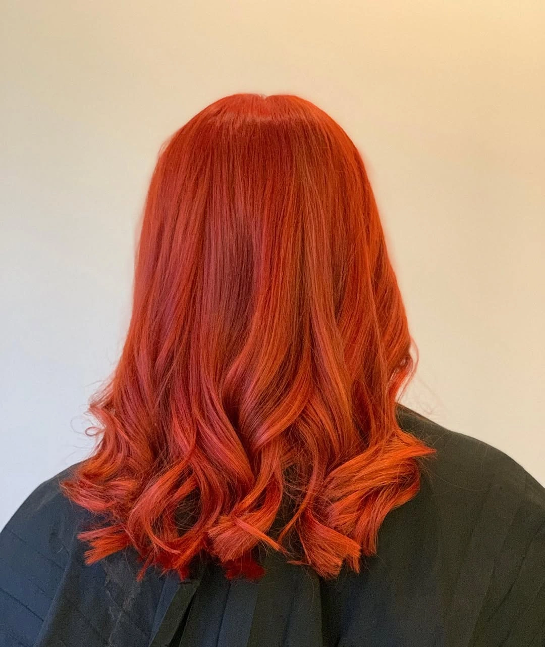 Shoulder length orange red hair with vivid copper tones and curled ends