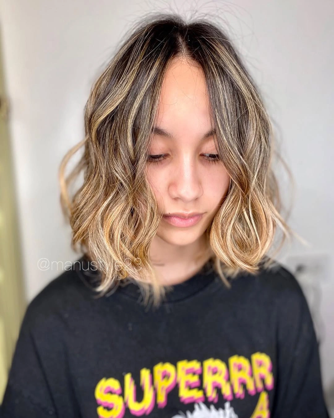 Short wavy bob with dark brunette roots and beige blonde lengths