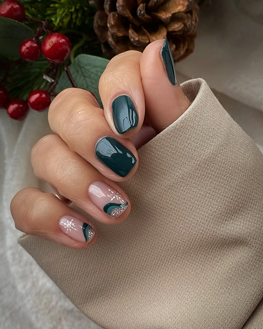 Short glossy teal and nude nails with fine white accents