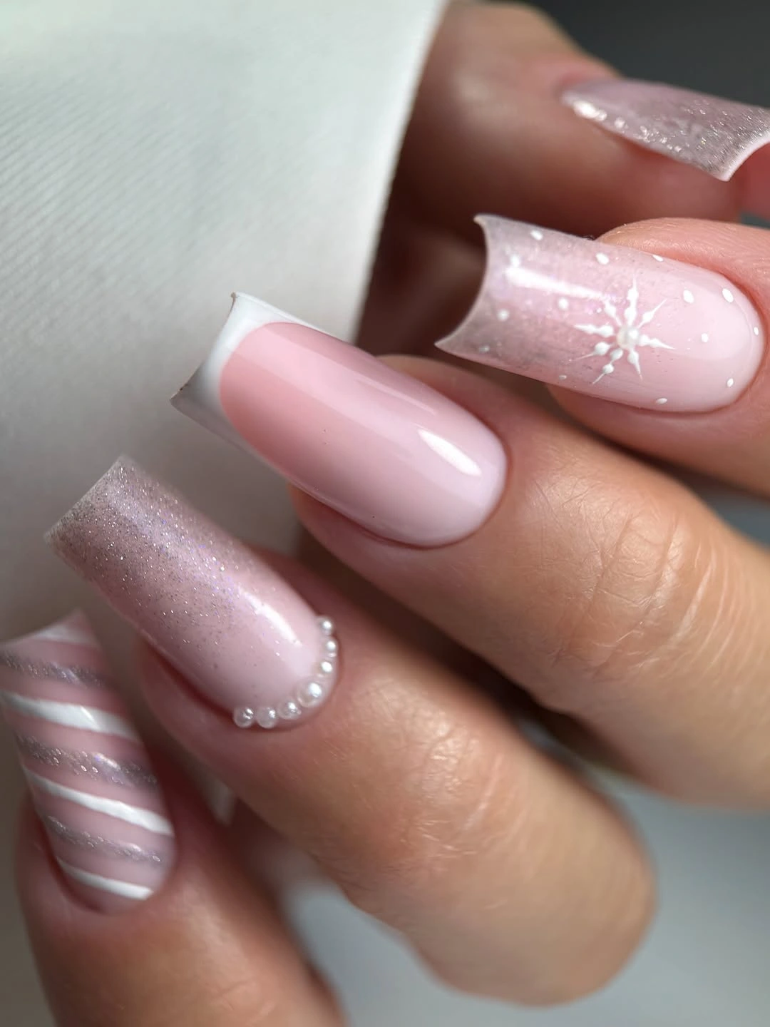Long almond shaped dusty pink nail with blue gift box and gold bow