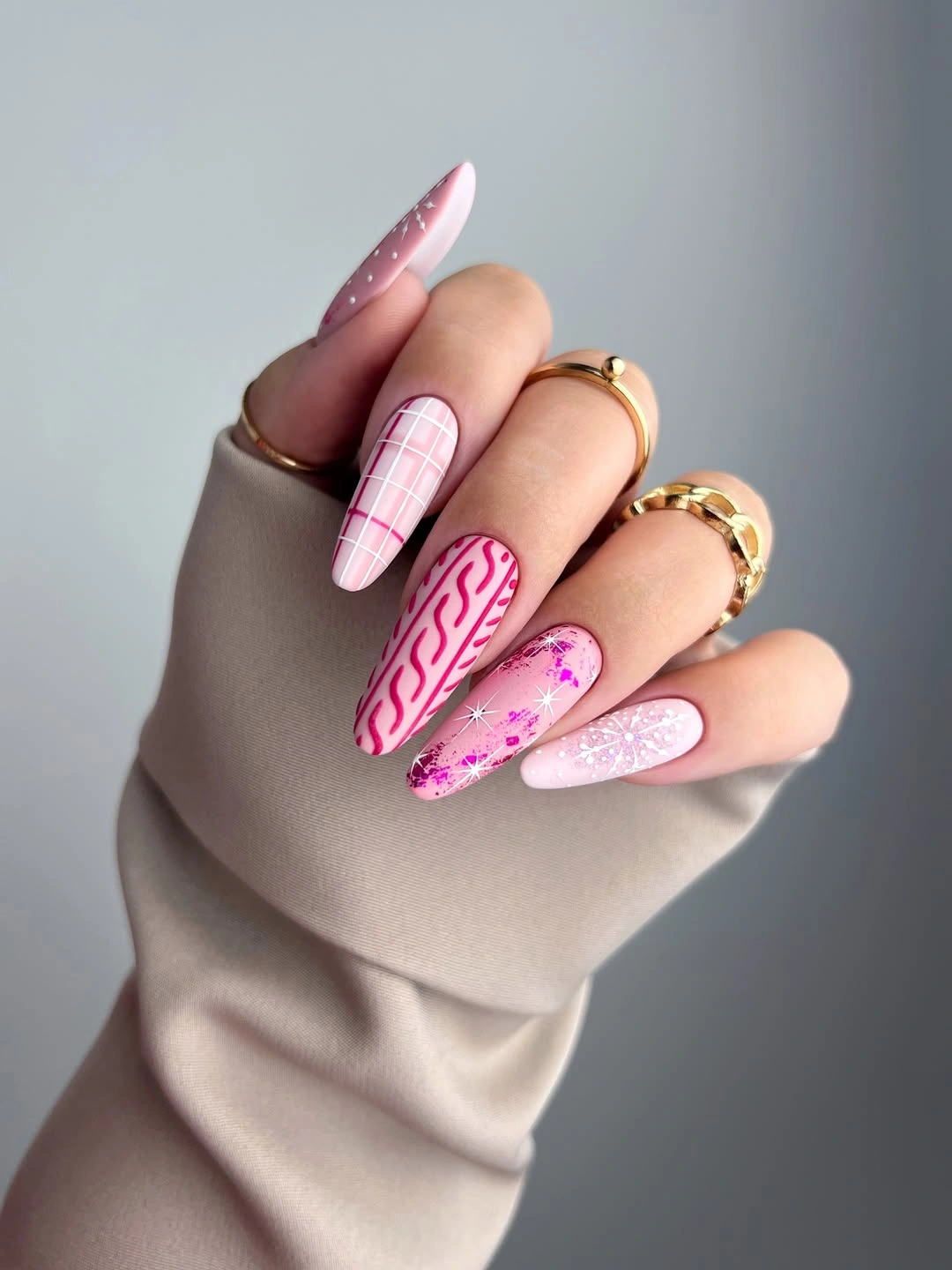 Extra long pointed pink nails with white grids glitter and snowflakes
