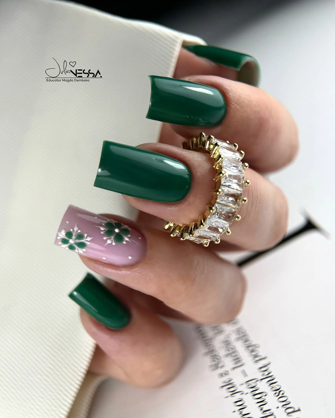 Long square emerald green nails with pink floral accent and white details