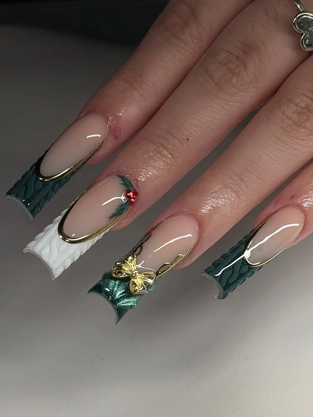 Long nude nails with sculptural green white and gold accented tips