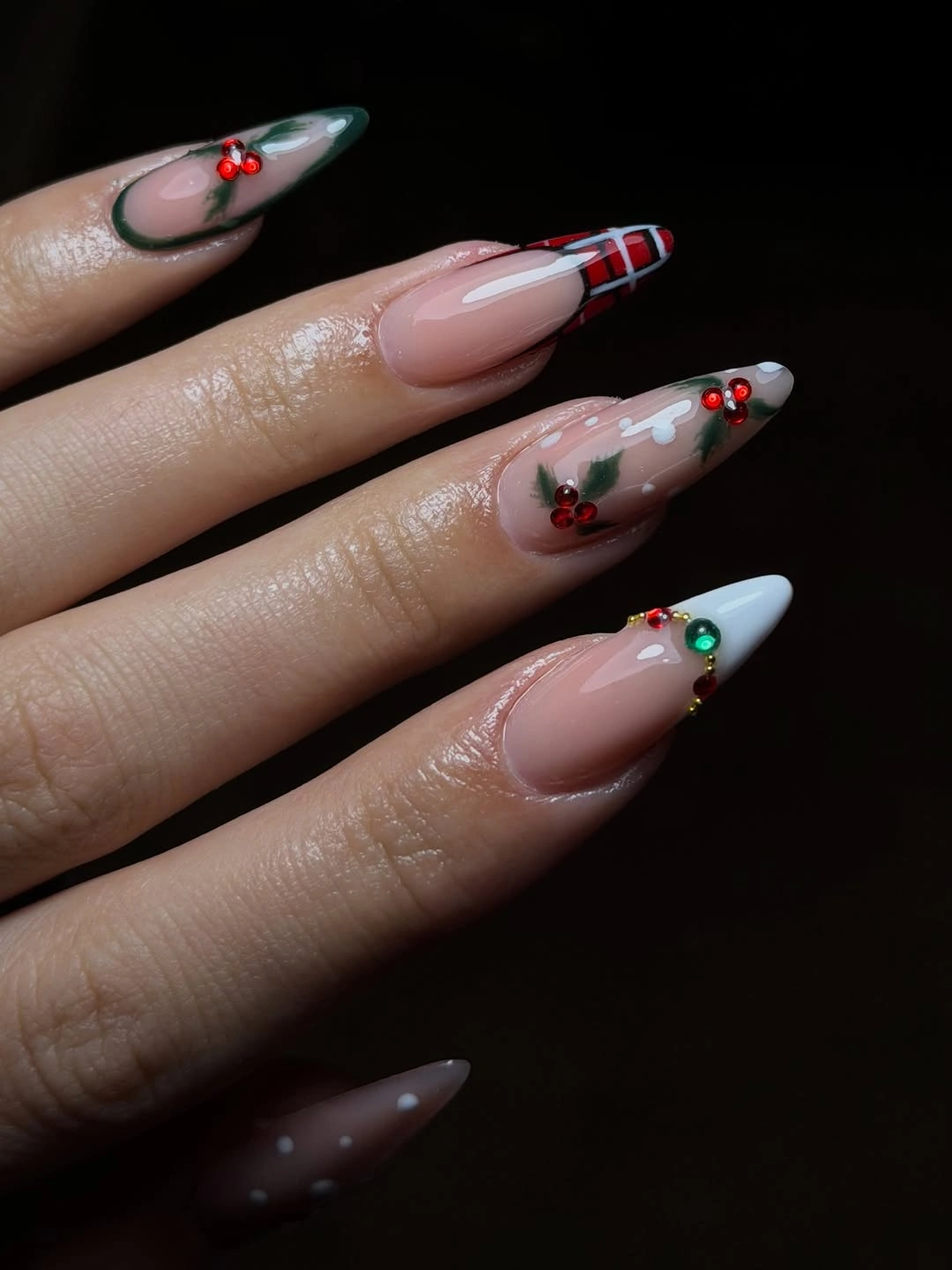 Long pointed nude nails with red plaid green leaves and berry accents