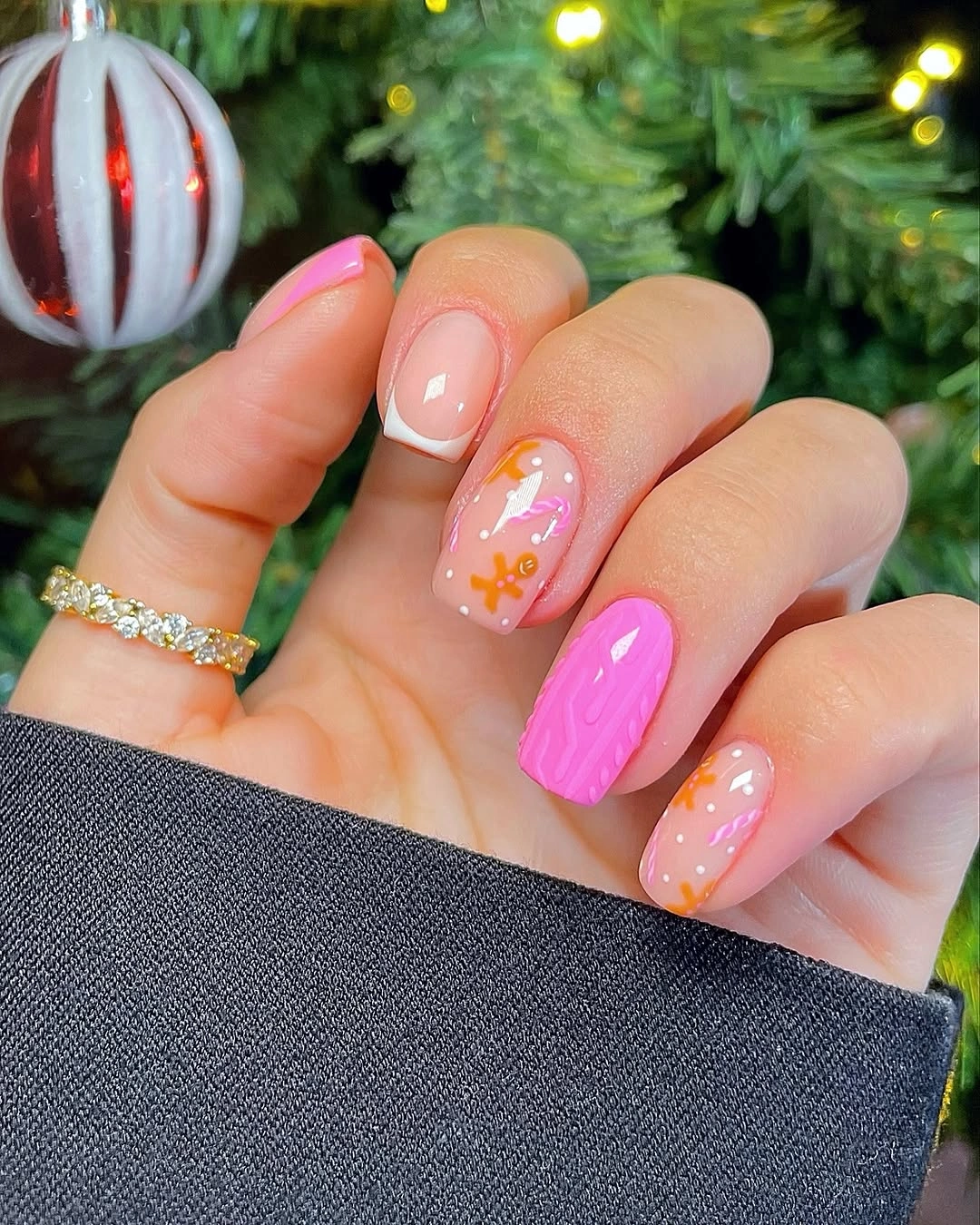 Pink nails with white French tips orange decorations and textured fuchsia accent