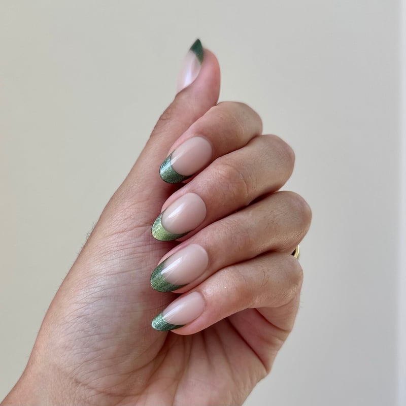 Medium Oval Nude Base Green Glitter Tips, Close-Up Take Medium Oval Nude Base Green Glitter Tips, Close-Up Take — Green Nails