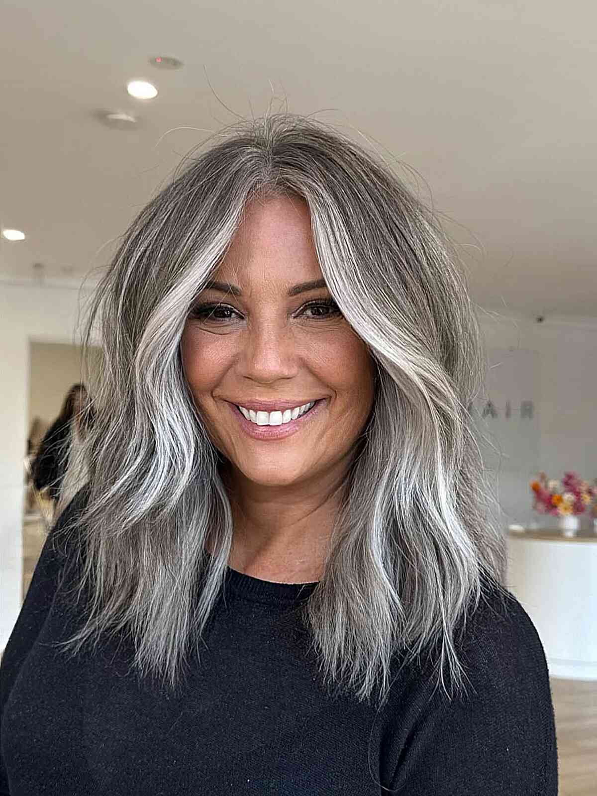 Collarbone Gray With Blonde Highlights And Curtain Bangs Collarbone Gray With Blonde Highlights And Curtain Bangs — Hair Color for Women Over 60