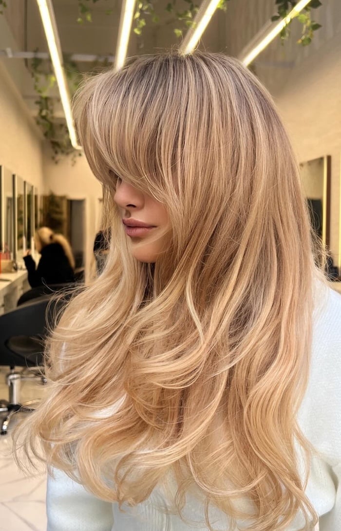 Long Peach Honey Blonde With Curtain Bangs