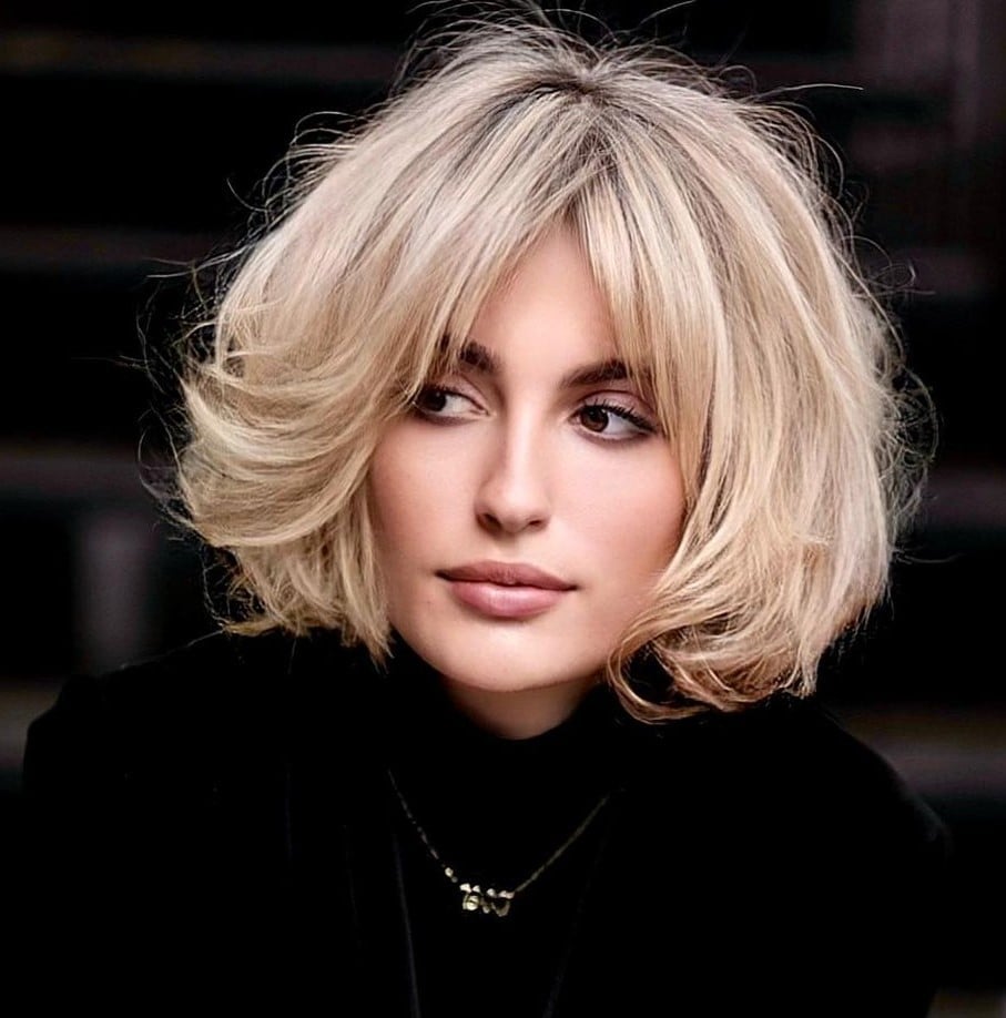 Voluminous Platinum Blonde Bob With Curtain Bangs Voluminous Platinum Blonde Bob With Curtain Bangs — Jaw Length Bob