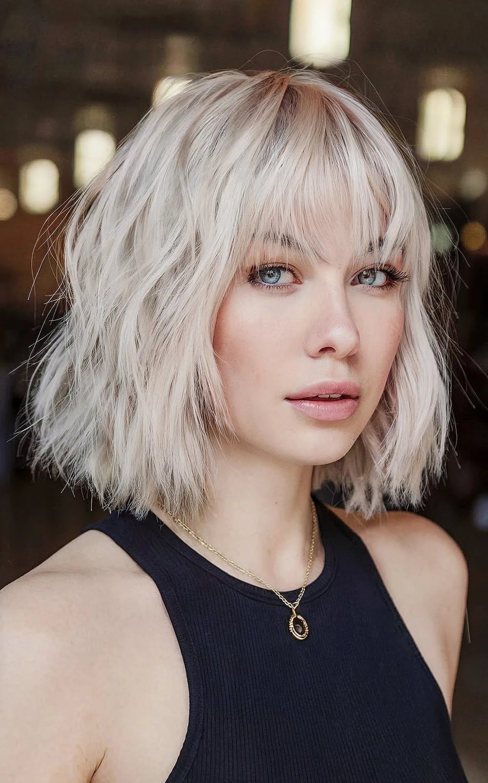 Platinum Blonde Layered Bob With Curtain Bangs