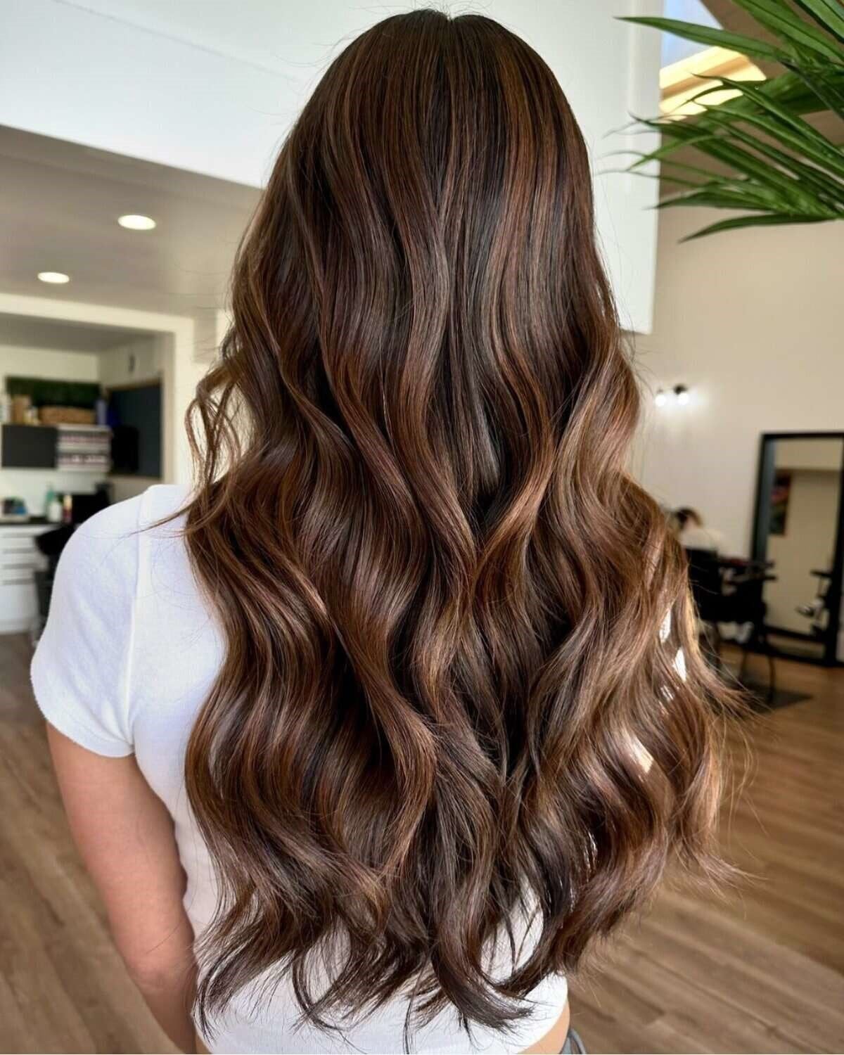 Long Wavy Brunette With Seamless Lighter Brown Highlights Long Wavy Brunette With Seamless Lighter Brown Highlights — Lived In Brunette