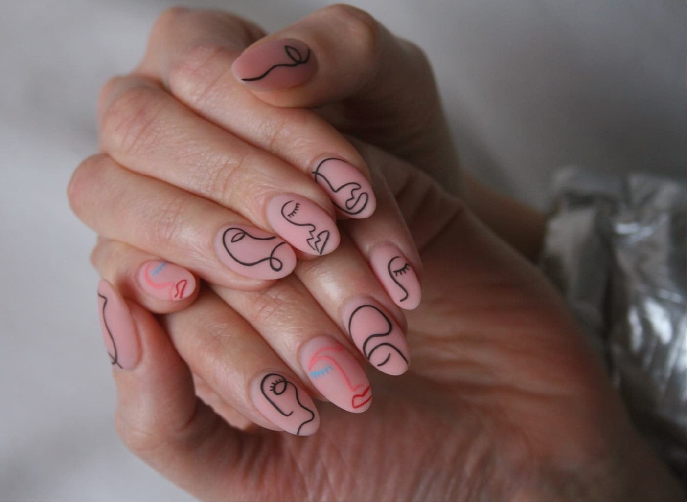 Pale Pink Matte Nails with Black Abstract Faces