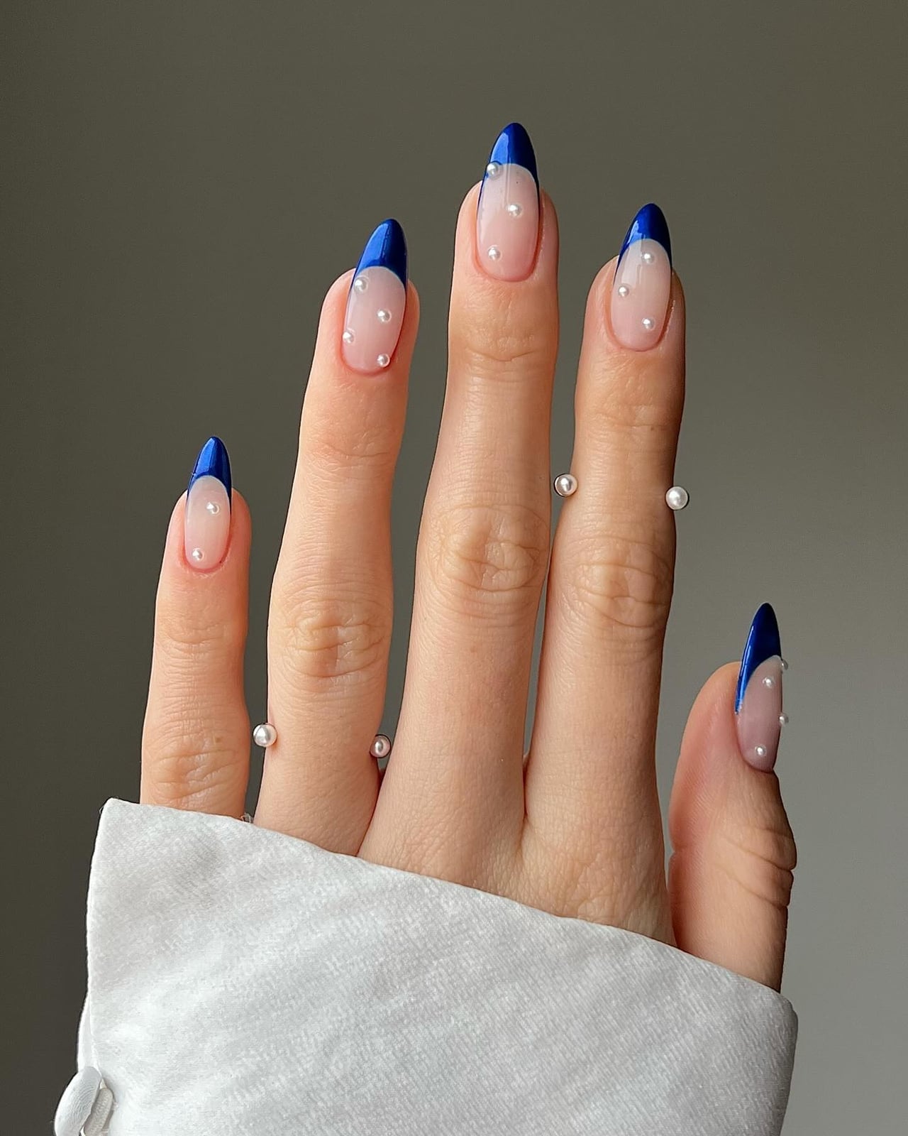 Stiletto Nails With Blue French Tip And Pearls Stiletto Nails With Blue French Tip And Pearls — New Years Nails