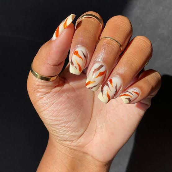 Long Almond Nails with Burnt Orange French Tip and Leaf Art — Orange Nails