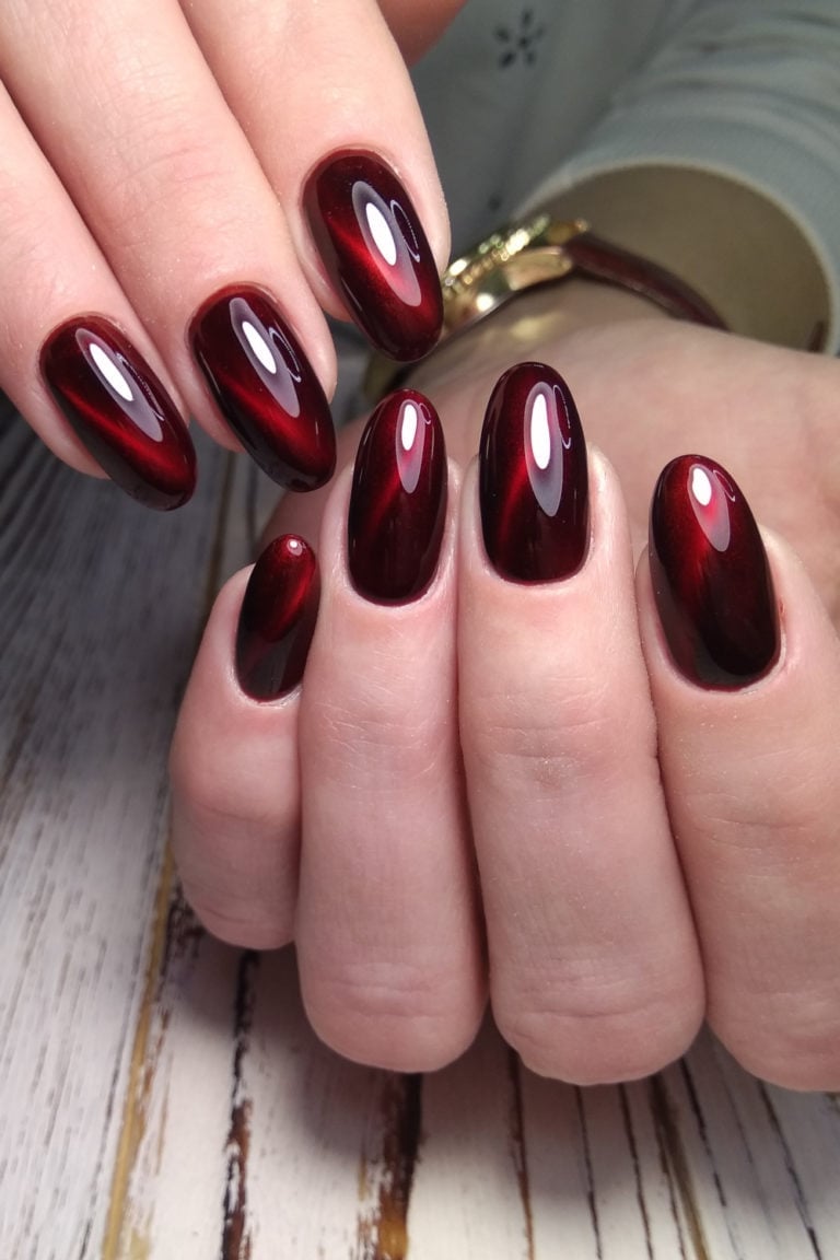 Deep Red Black Undertone Cat-Eye Medium Oval Nails, Close-Up Take — Red Nails