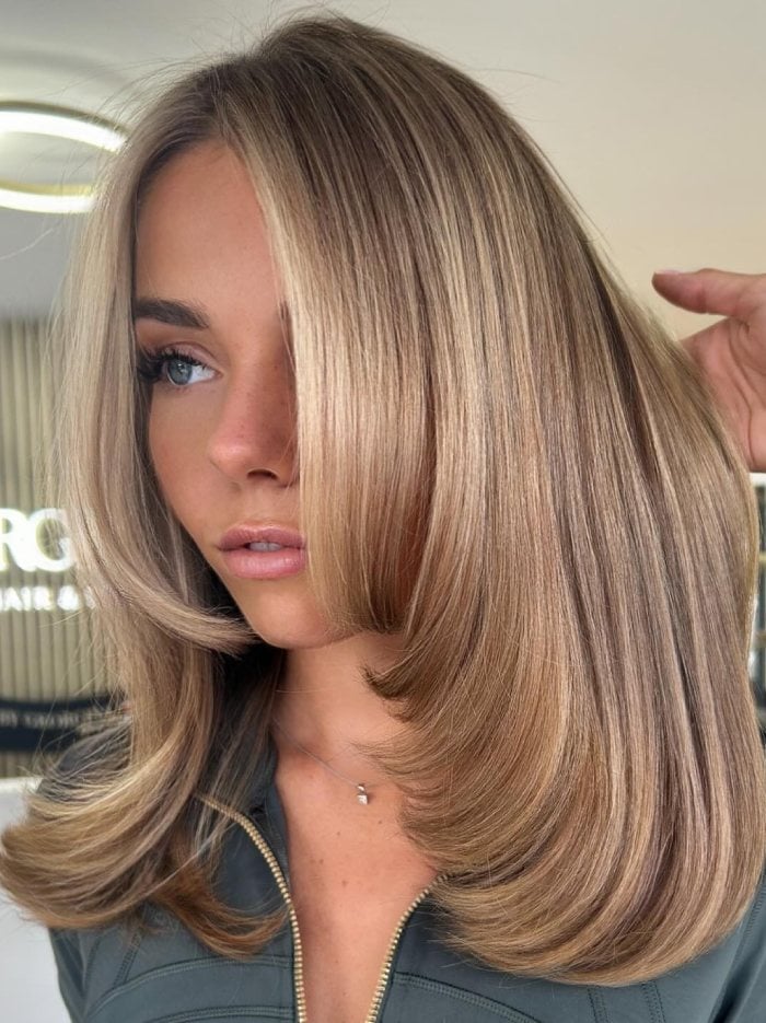 Neutral Blonde Collarbone Blowout With Face-Framing Neutral Blonde Collarbone Blowout With Face-Framing — Reverse Balayage