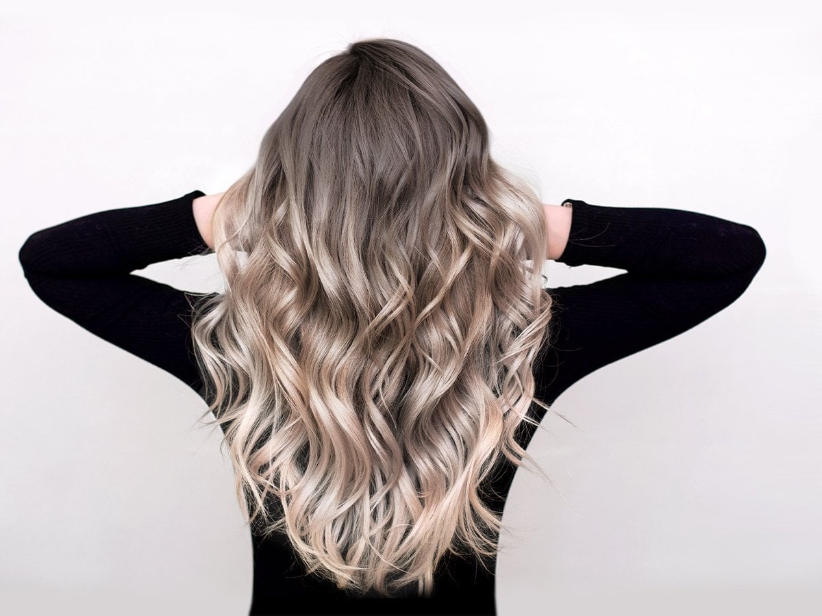 Ash Blonde Balayage Mid-Back Waves, The Texture Appears Thick And Wavy Ash Blonde Balayage Mid-Back Waves, The Texture Appears Thick And Wavy — Reverse Balayage