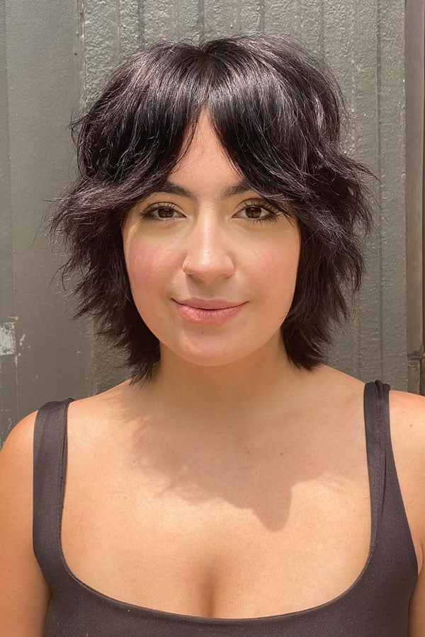 Voluminous Black Shag With Full Bangs, Wavy, Presented In A Front View — Short Shag