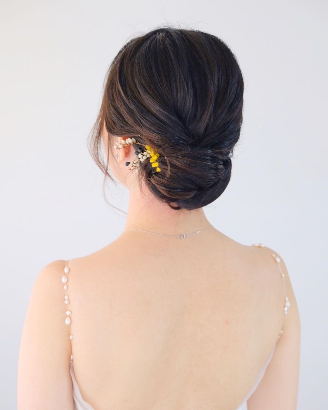 Dark Brown Smooth Low Bun With Flower Pins — Updos for Short Hair