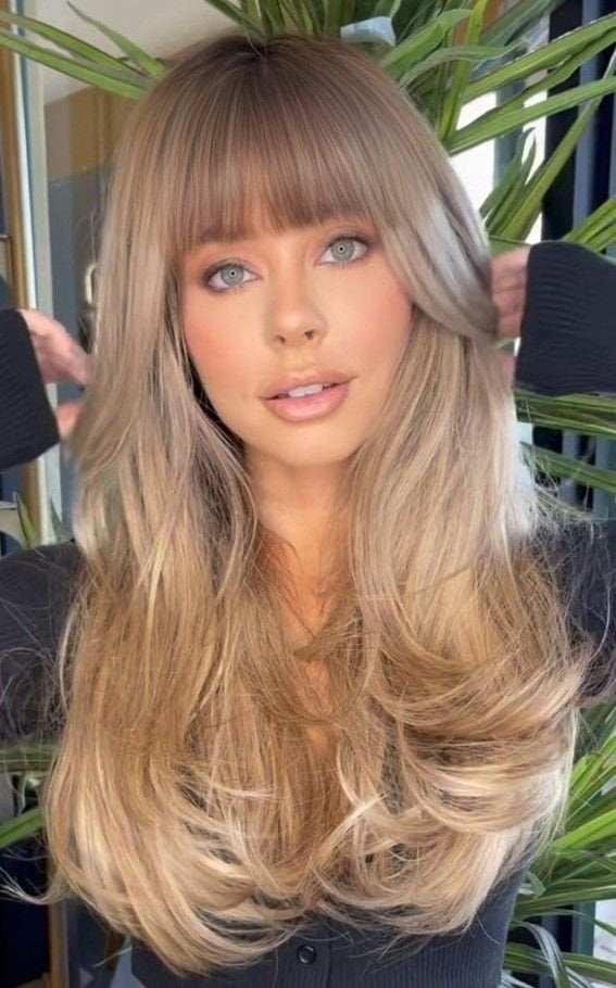 Ash Blonde Layers With Soft Blowout And Wispy Bangs Ash Blonde Layers With Soft Blowout And Wispy Bangs